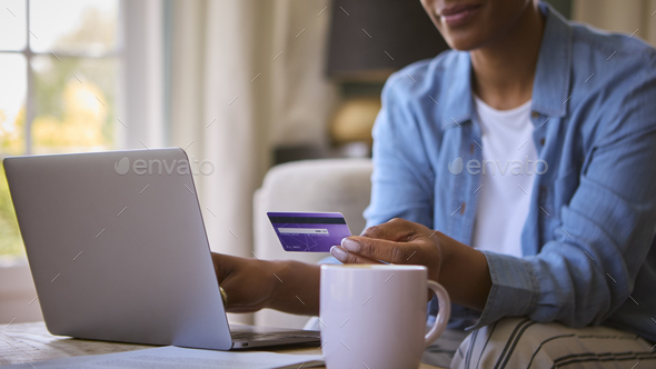 Close Up Of Woman At Home With Laptop Using Credit Card To Make Online Purchase Or Book Tickets