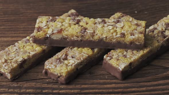 Chocolate muesli bars on old wooden table