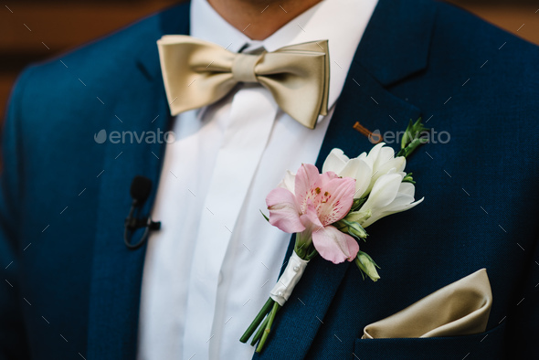 Man in a suit and bow-tie close up. On the jacket - buttonhole