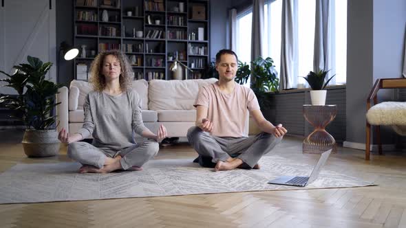 Couple Doing Morning Exercise in Home Interior