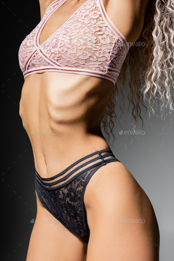fashion and femininity, sexy woman with toned body and wavy ash blonde hair  posing in lace bra Stock Photo by LightFieldStudios