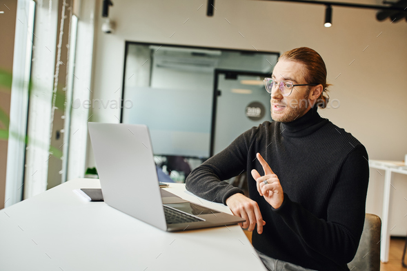 stylish businessman in black turtleneck and eyeglasses showing ...