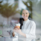 Portrait of a young woman with a smiling face in a coffee shop. - PhotoDune Item for Sale