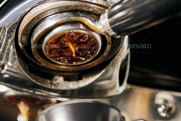 black coffee, extraction, hot espresso dripping into cup, professional  coffee machine Stock Photo by LightFieldStudios