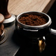 barista holding portafilter with grinded coffee, tamper, cafe, alternative  brew, top view Stock Photo by LightFieldStudios