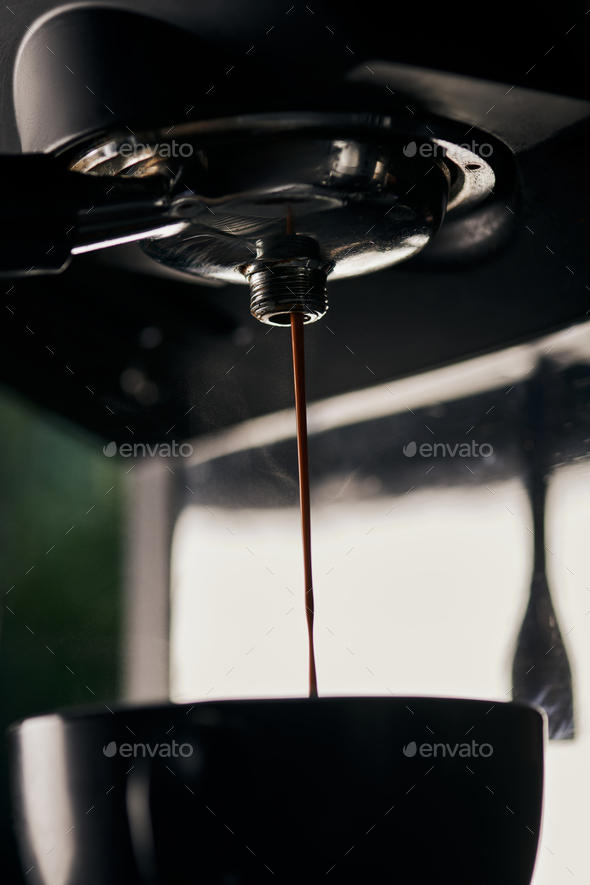 black coffee, extraction, hot espresso dripping into cup, professional  coffee machine Stock Photo by LightFieldStudios