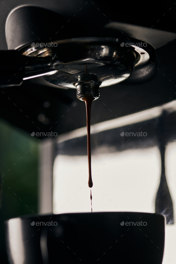 coffee extraction, drops, hot beverage, espresso dripping into cups,  professional coffee machine Stock Photo by LightFieldStudios