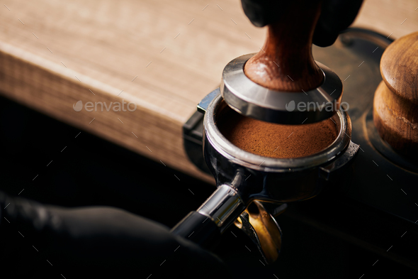 barista holding tamper near portafilter with grinded coffee, espresso, manual  press Stock Photo by LightFieldStudios