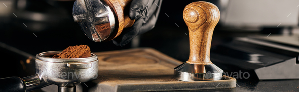 barista holding tamper near portafilter with grinded coffee, espresso, manual  press Stock Photo by LightFieldStudios