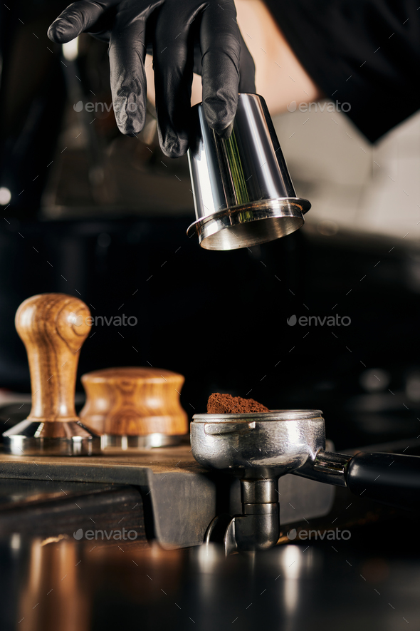 barista holding tamper near portafilter with grinded coffee, espresso, manual  press Stock Photo by LightFieldStudios