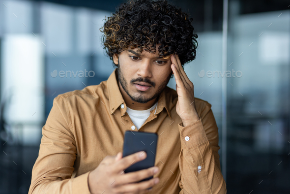 Close up of man upset and disappointed reading bad news online, businessman working at workplace