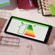Energy class and efficiency app on phone over architectural plans - PhotoDune Item for Sale