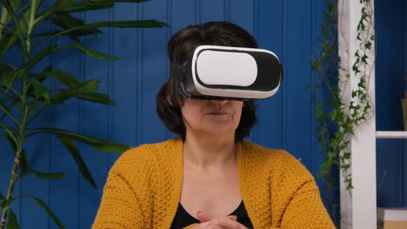 Middle Aged Woman Wearing Vr Goggle 3d Visualization and Exploring in Metaverse Futuristic Lifestyle