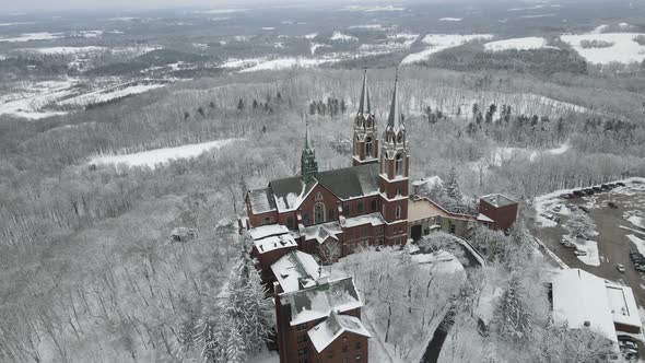 Top view of church on mountain with surrounding forest.