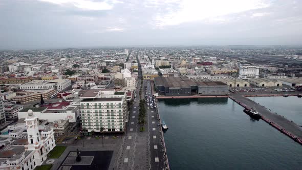 backwards drone shot of the main port of veracruz and its surroundings alt