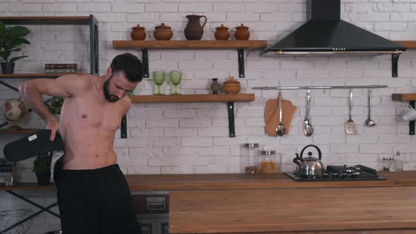 a Man Puts on a Massage Belt alt