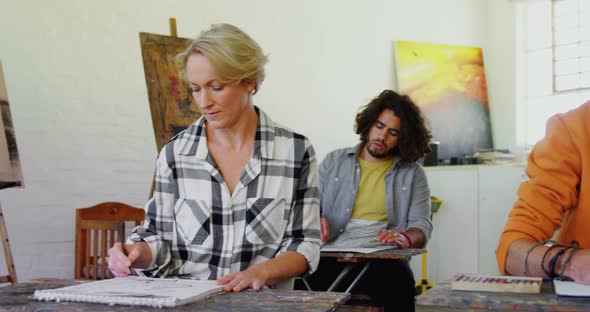 Artist practicing drawing on canvas 4k alt