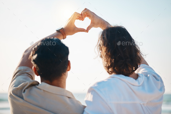 Love, heart hands and gay men on beach, hug from back on summer vacation together in Thailand. Suns