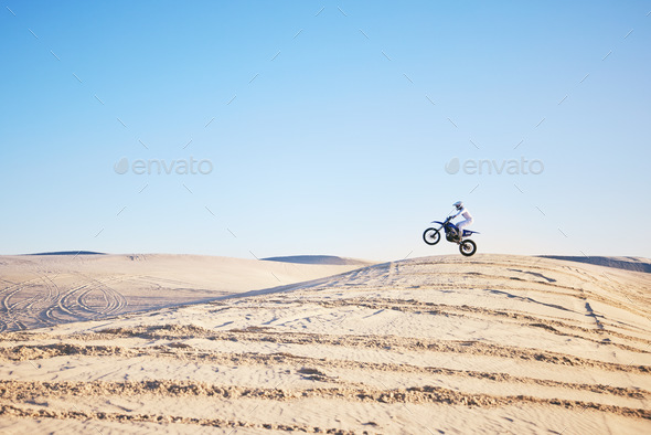 Desert, bike jump or sports person travel, agile and air trick on sand hill adventure, exercise or