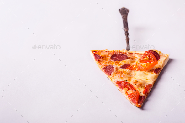 Piece of pepperoni pizza with sausages and tomato on white background