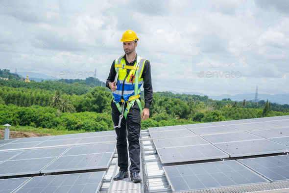 Engineer working and maintenance with solar batteries near solar panels.