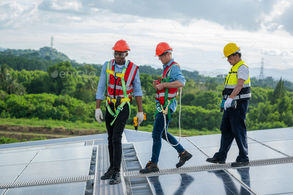 Engineer with technician working and maintenance with solar batteries near solar panels.