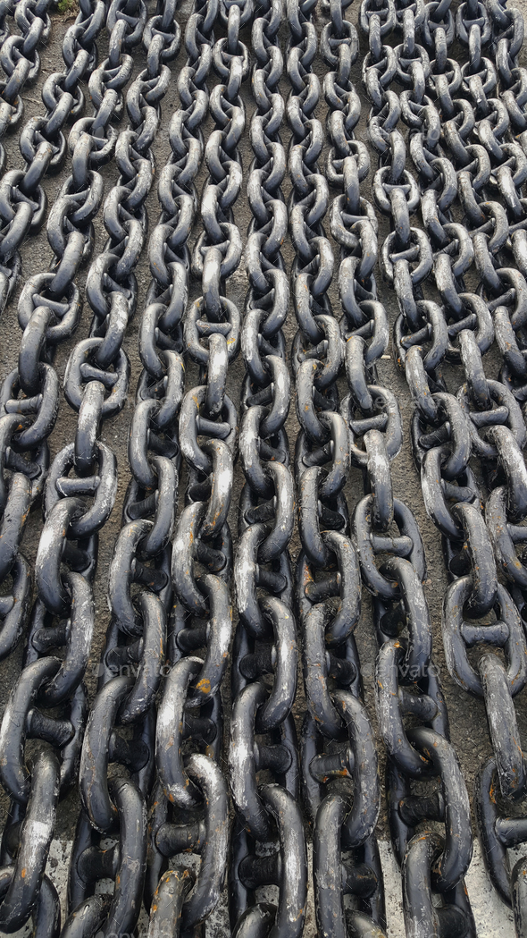 Rusty ship anchor chain in harbour Stock Photo by wirestock