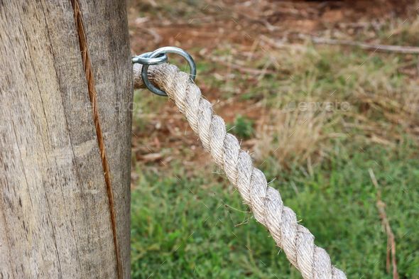 wooden post and rope fence Stock Photo by wirestock