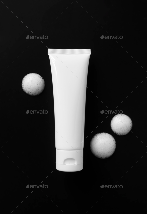 White plastic tube mockup with moisturizer cream, shampoo or facial cleanser and soap foam spots