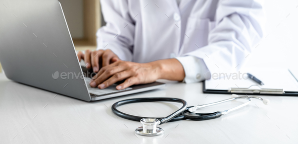 Doctor working with laptop checking patient history form while think about finding a diagnosis