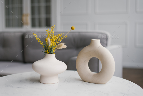 Two Decorative Ceramic Modern Round Vases with a Hole Inside on the Table in the Living Room