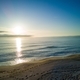 Black Sea and beach nearby against a sky with clouds and a dawn sun - PhotoDune Item for Sale