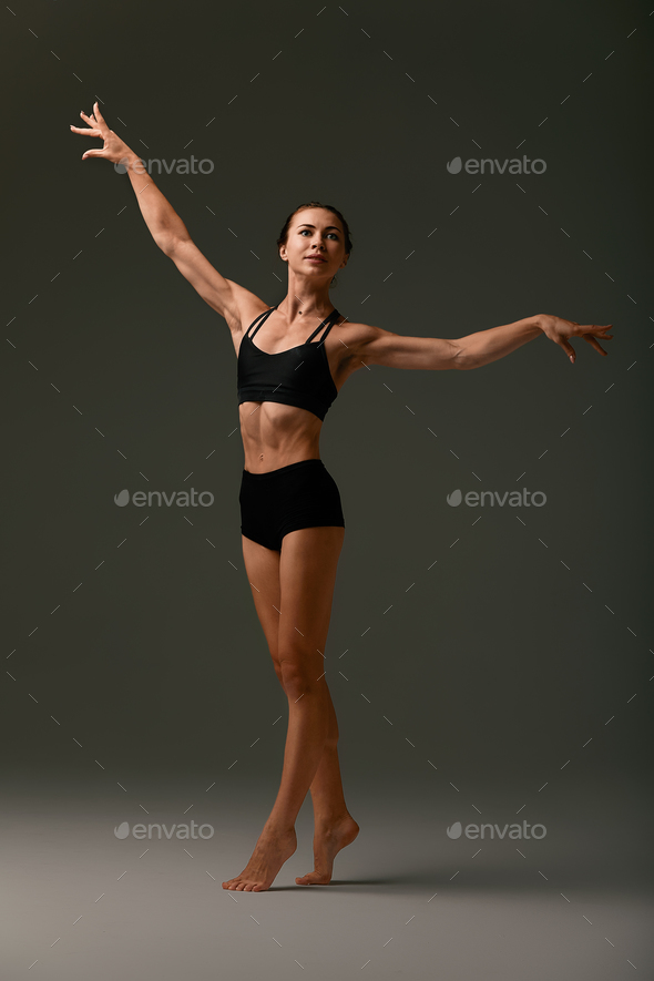 Emotional Female Ballet Dancer in Body Suit and Posing in Dance in