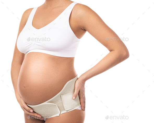 Belly of pregnant woman with elastic maternity band
