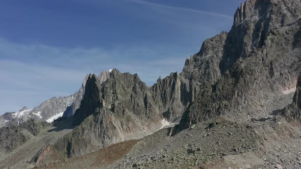 Slowly flying over rocky mountain slope alt