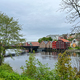  Trondheim Norway colorful old storehouses flanking both sides of Nidelva river framed by trees  - PhotoDune Item for Sale