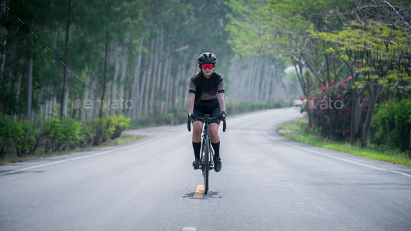 Portrait sport woman wearing sport suite helmet,glove and glasses,she competition on bicycle bike is