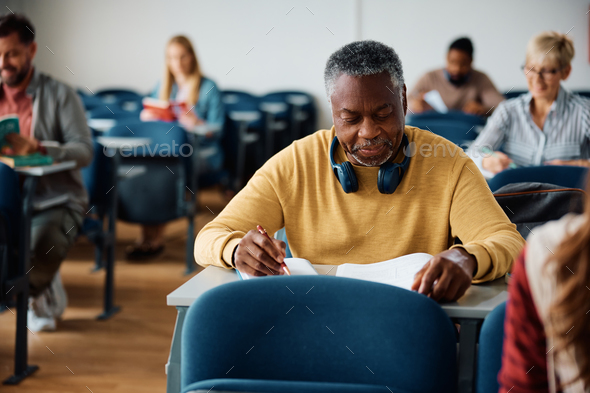 Older black man learning during adult education course in the classroom.