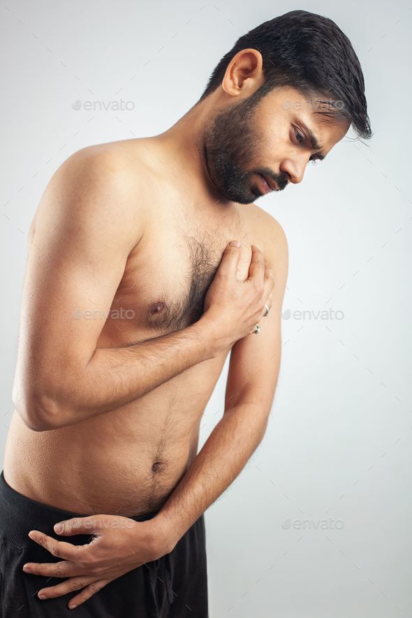 young health man clutching his chest with burning pain, heart attack, heart burning