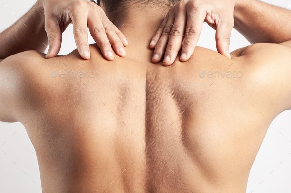 trapezius muscle pain, man suffering from pain on spinal cord or shoulder muscle