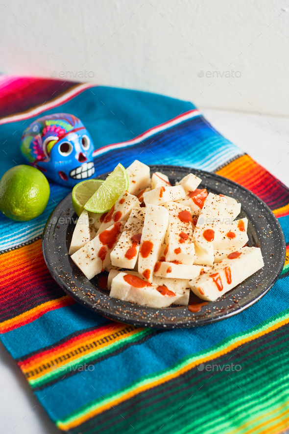 Mexican Traditional snack, jicama or yam bean, with chili, chamoy
