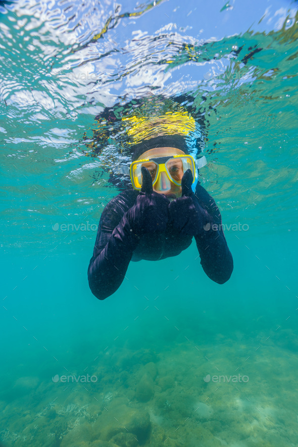 woman using a stinger suit in the great barrier reef in summer