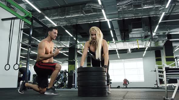 Beautiful Young Woman Doing Push-ups while Her Coach Counting alt