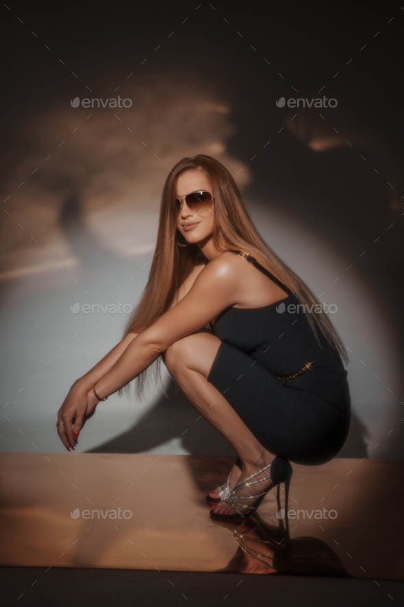 Beautiful luxury woman in fashion long dress with slim waist. Glamour  make-up, sexual pose, long straight hair Stock Photo by ©Seprimoris 48057505