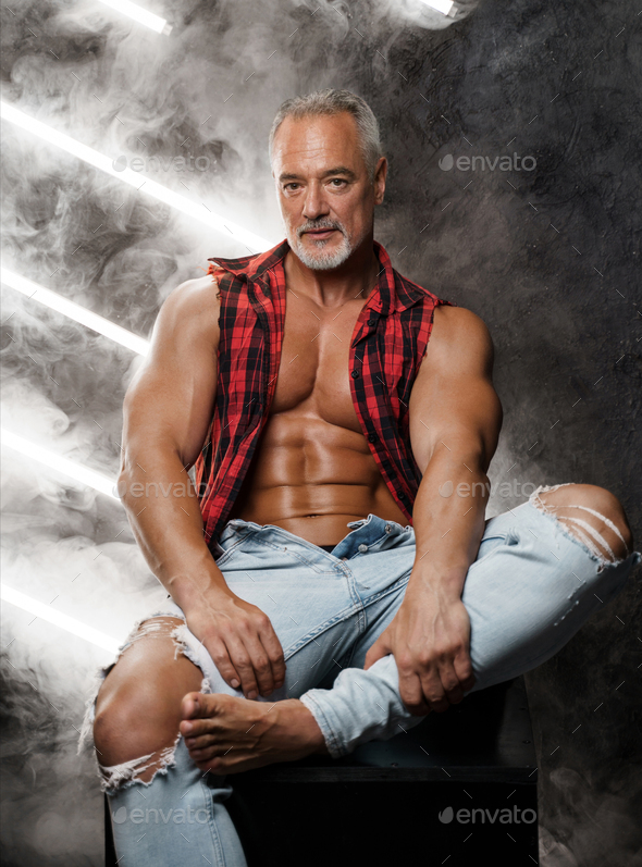 Masculine middle-aged male model with chiseled torso grey beard and bare chest