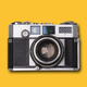 vintage old film camera on yellow background - PhotoDune Item for Sale