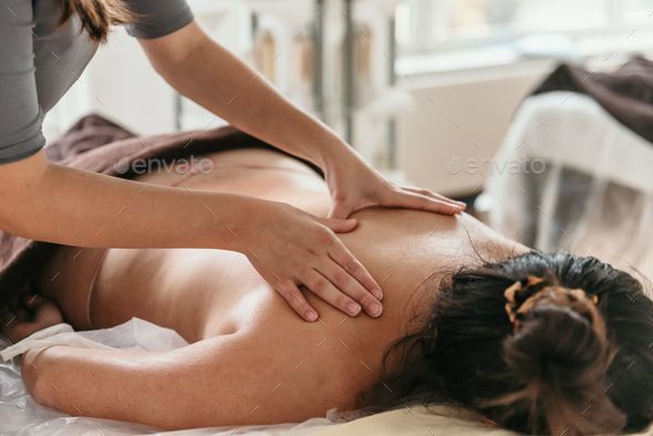 Young Beautiful Woman Getting Back Massage Stock Photo, Picture