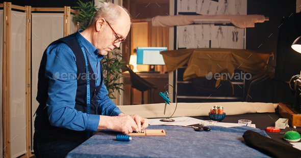 Seamstress using measuring tape Stock Photo by DC_Studio