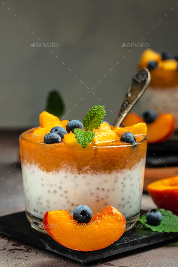 yogurt dessert with peaches blueberry chia Stock Photo by kovalnadiya