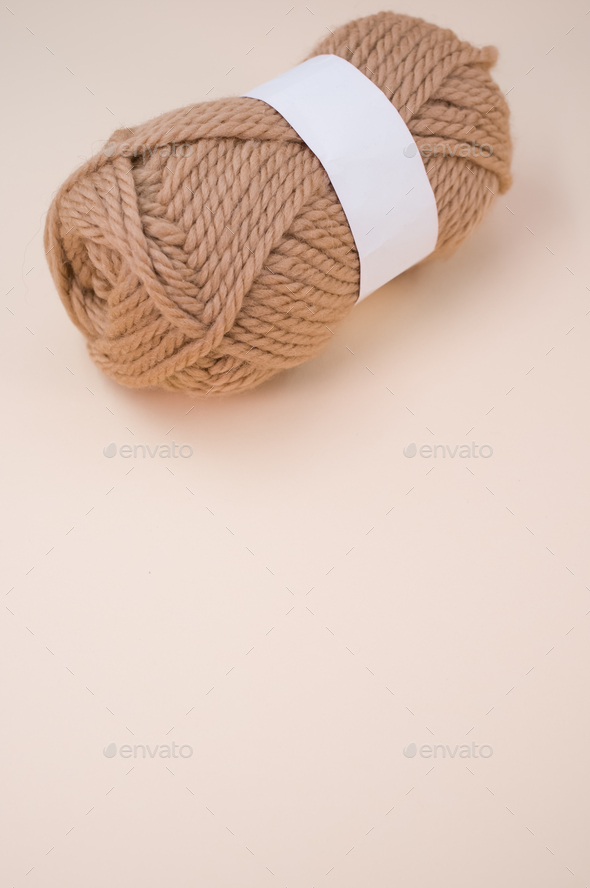Vertical shot of isolated soft beige yarn ball on an a coral background  Stock Photo by wirestock